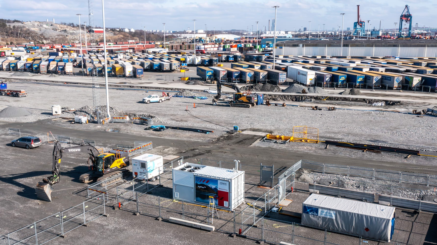 In a groundbreaking collaboration, the Port of Gothenburg has teamed up with Hitachi Energy and Skanska to pilot a new hydrogen generator technology in one of its largest infrastructure projects to date. This innovative generator, designed as a scalable, portable plug-and-play solution, was utilized for emission-free excavation work at the Arendal 2 terminal area, showcasing its efficiency and adaptability on the field. Developed in partnership with PowerCell Group, the generator comprises fuel cell modules, power electronics, cooling systems, auxiliary systems, and an intelligent control mechanism, facilitating easy relocation and use across various project sites. The first field test of this technology at the Port of Gothenburg successfully powered a Volvo electric excavator via a green hydrogen-fueled charging station supplied by Linde Gas, marking a significant step towards sustainable construction practices. Arendal 2 represents the most ambitious terminal expansion in the port since the 1970s, with a focus on sustainability and innovation from the outset. Utilizing modern techniques for material stabilization and solidification, the project is a testament to the port's commitment to environmental stewardship and cutting-edge solutions. The Port of Gothenburg is not only Scandinavia's largest port but also a leading advocate for the transition to fossil-free maritime and land transport. With a goal to slash CO2e emissions by 70 percent across its operations, the port is exploring the versatile applications of hydrogen as a fuel source for trucks, trains, terminal equipment, ship propulsion, and shore power support. This initiative underscores the port's holistic approach to integrating hydrogen technology seamlessly into its operations, reinforcing its position as a leader in sustainable port management and operations.